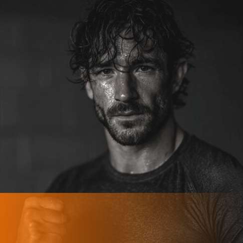 Sweat-covered man staring ahead during an intense workout