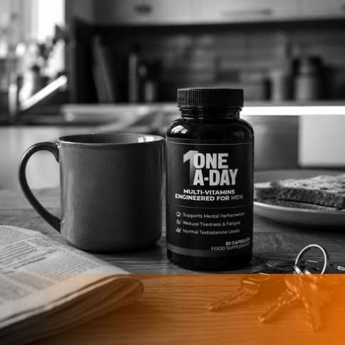 Black One A-Day multivitamin bottle beside a mug on a kitchen counter