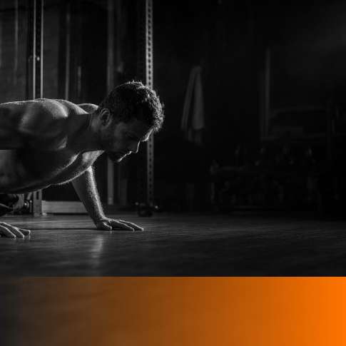 MenTools blog feature image for 7 Best Push-Up Apps for Men — black and white photograph with orange MenTools overlay