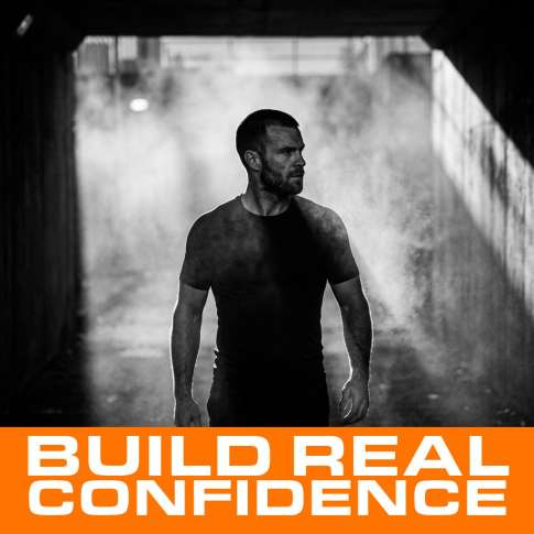 MenTools blog feature image for MEN: How Can a Man Become More Confident? What Actually Works, black and white photograph with orange MenTools overlay